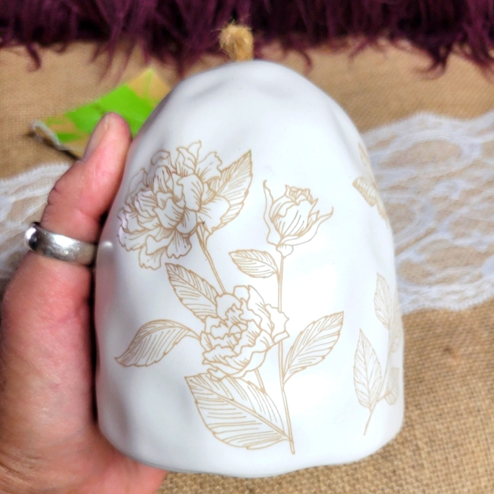 Evergreen decorative ceramic bell with flowers on the outside